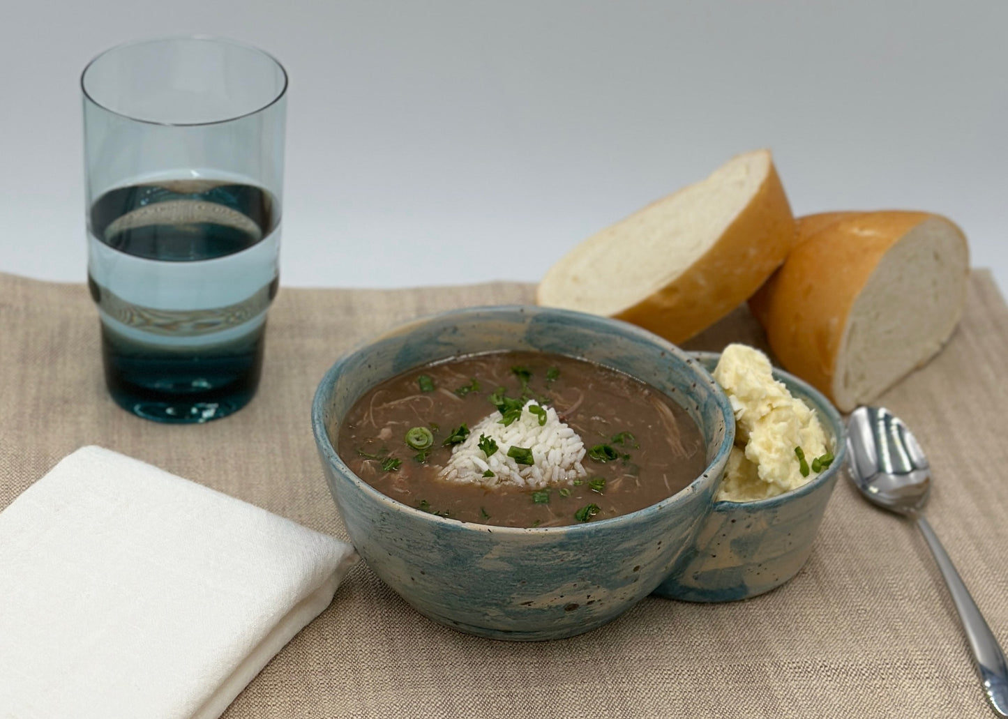 One Gumbo bowl with potato salad bowl attached